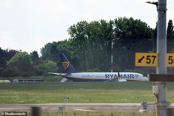 Operations at Belgium's second largest airport have been suspended due to a bomb alert on a Ryanair plane today. Pictured: The Ryanair airplane on the ground following the alert