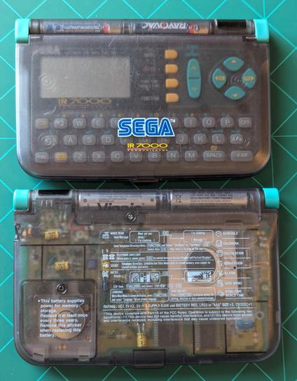 The front of the Sega ir7000 communicator with its protective shell closed in all of its Smokey transparent Glory 

The back of the unit is also transparent and you can see the circuit board and capacitors. There are also various instructions on how to operate the system but it's really not very helpful. LOL