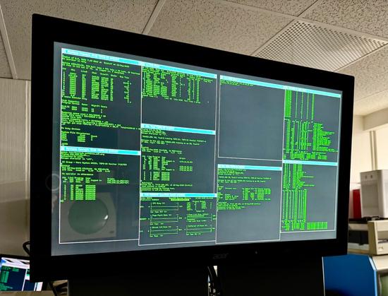 A display screen with several windows open showing the remote systems status