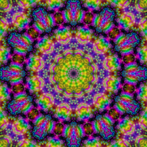 Mandala made of rainbow crystals with rings of yellow and purple around the center