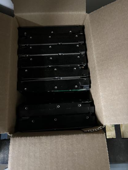 Photo of a bunch of neatly boxed 5.25” hard disks.