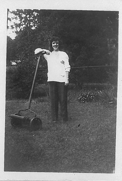 Black and white image of a young woman mowing grass with a manual reel mower,  Philadelphia, Pennsylvania, USA, 1946.