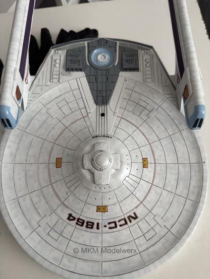 Bottom of the model with the registry decal “NCC-1864” and red stripes applied.