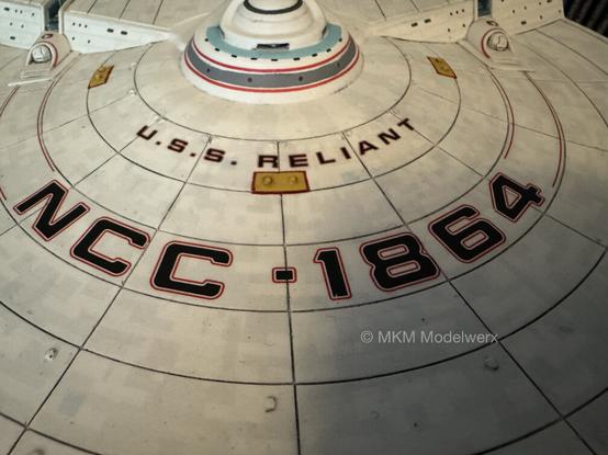 Top from view of the saucer of the USS Reliant showing its name and registry number.