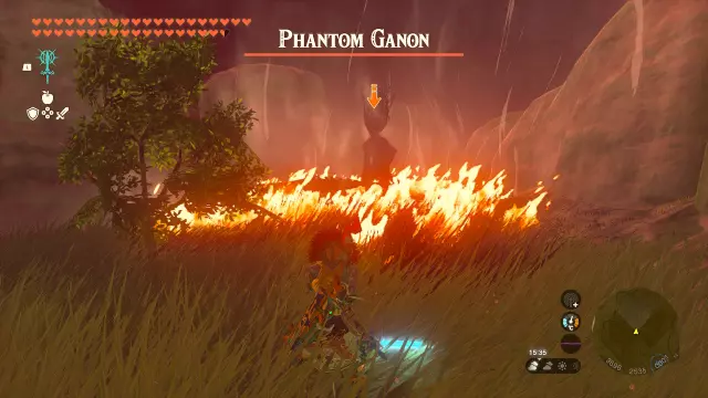 Screenschot of Tears of the Kingdom on the Nintendo Switch. It shows Phantom Ganon spawning in, but the grass all around him was set ablaze, so it just looks like a hellish scene.