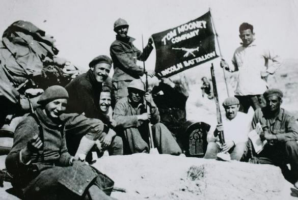 The accompanying photo shows Oliver Law, and the Tom Mooney Machine Gun Company, part of the Abraham Lincoln Brigades, who fought in the Spanish war against fascism (AKA the Spanish Civil War). Oliver Law was a communist, and the first black man known to have commanded white U.S. troops.