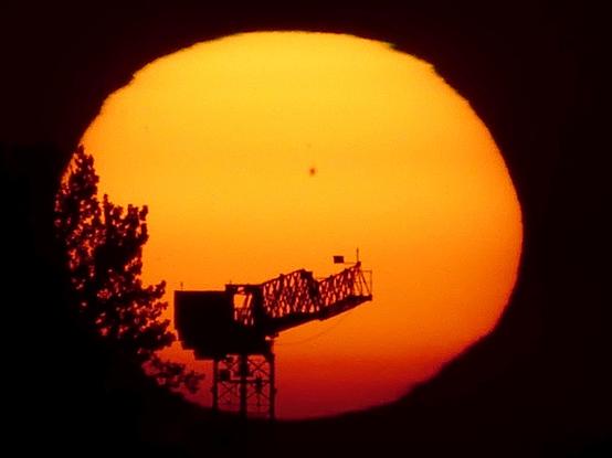 The sunspot prominent while the Sun is compressed by refraction.