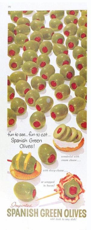 Two thirds of the top are green olives with their red centers. The bottom part are sliced olives on a cracker, one with cheese and another with bacon