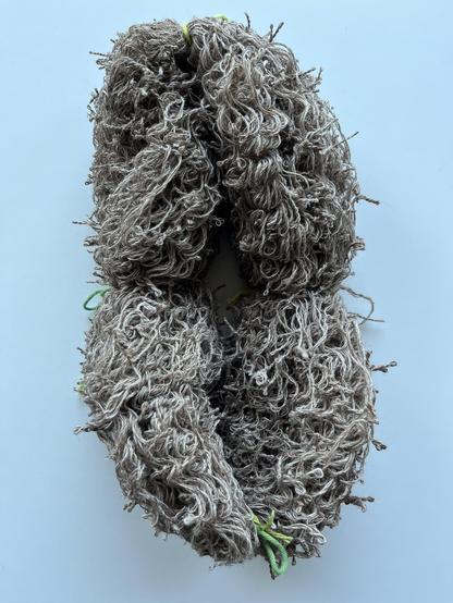Thick loop of very curly energized thin yarn.