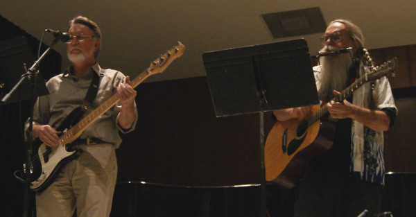 Hairy Larry and George singing in the Fine Arts Recital Hall at Arkansas State University. George on bass and Hairy Larry, guitar and harmonica.