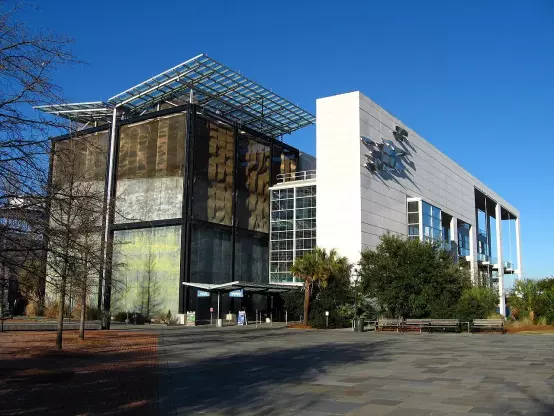 This image appears to depict a modern building with a distinctive architectural design. It features a combination of materials including a glass facade and a textured surface, possibly indicating a cultural or educational institution. The presence of landscaping and clear blue skies suggests an outdoor area, likely open to the public. If you have specific questions about the building or its purpose, feel free to ask!

Image Credits: Wikimedia / JonathanLamb / Public domain