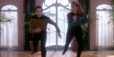Data and Beverly dancing in a dance studio setting