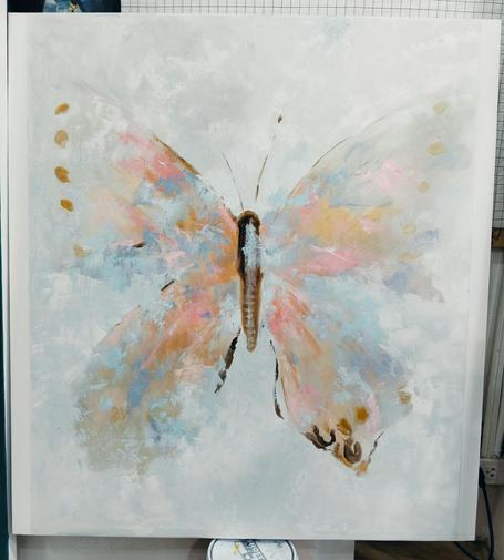 a butterfly, large, painted on a white background in  an abstract impressionist method in tones of pink and gold and light blue
