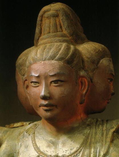 a close-up of one of the faces, the faces are light red
