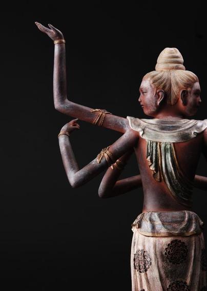 a photo of half the sculpture from mid-thigh up, taken from behind