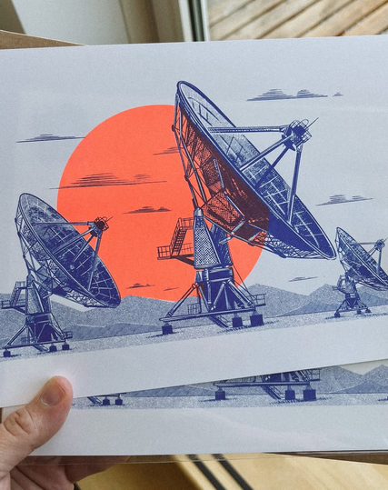 Risograph print in blue and fluorescent orange of radio telescope dishes in a desert with a big sun behind them. Very graphic style.