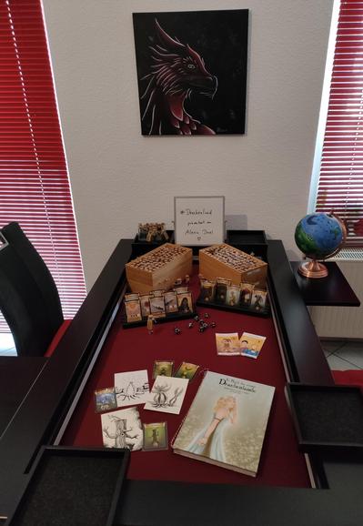 Mein Spieltisch auf dem ihr Bambusboxen mit vielen Phiolen, Spielkarten, Bildern und mein Drachenland-Buch seht. Ebenso eine Weltkugel, auf der die Welt aus Drachenland zu sehen ist. Alles wird in meinem Spiel verwendet.