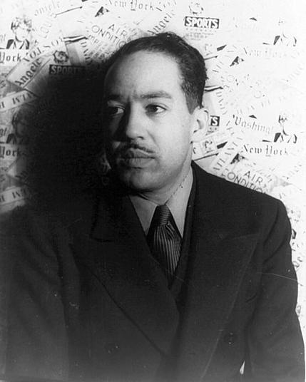 1936 photo by Carl Van Vechten of Hughes, in a suit, looking to the side, with newspapers in the background. By Carl Van Vechten; cropped by Beyond My Ken (talk) 07:07, 5 August 2010 (UTC) - Library of Congress Prints &amp; Photographs Onlince Collection, Public Domain, https://commons.wikimedia.org/w/index.php?curid=11094717