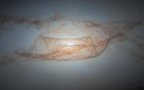 This Hubble Space Telescope image showcases a nearly edge-on view of the lenticular galaxy NGC 4753.