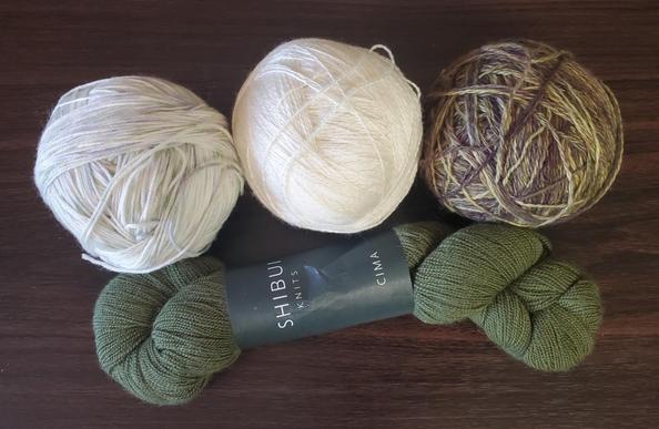Four yarns, two light  shades and two dark, greens and purples