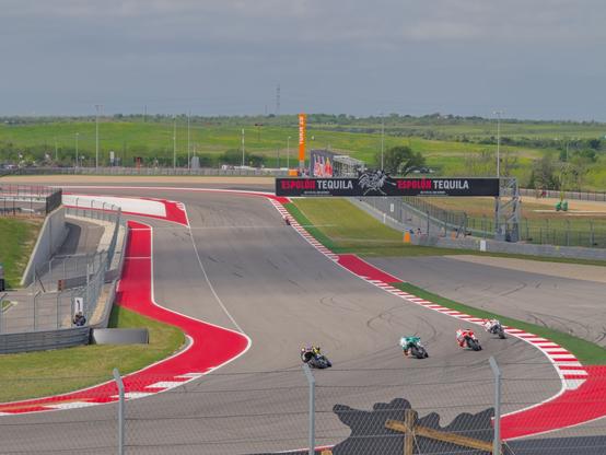 Motorcycles going around a turn on the track