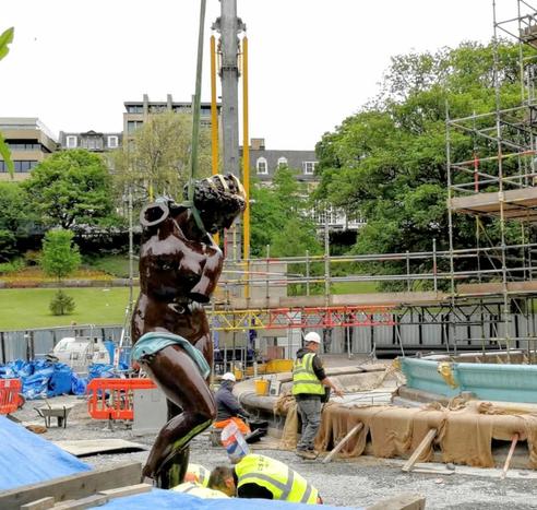Image of if the main fountain figure with rope around it's neck about to be hoisted high to sit on top on the Ross Fountain, Edinburgh