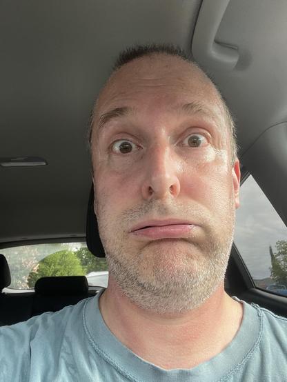 a selfie of me after the first track was emptied. I am sweaty and making an exhaling big lips face. I am in the car (i had to take a load of stuff to the dump/recycling centre