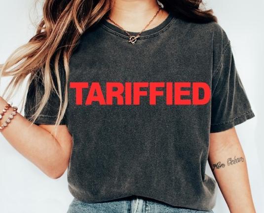 Screengrab of a woman wearing a black T shirt with "TARIFFIED" written in large red block letters.

I mean, it is terrifying. And Trump supporters are afraid. Outside the hard core of the cult a lot of them just need to see enough shirts like this and enough people marching. It's already happening.