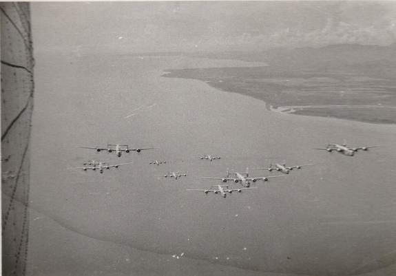 A squadron of B-24, WW2 planes in the sky over the Pacific ocean.