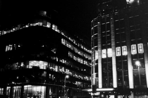 A black and white photograph of the city of Glasgow at night
