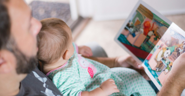 Dad reads to his baby