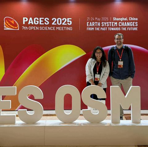 Me and Izabella Baisheva standing in front of a conference banner.