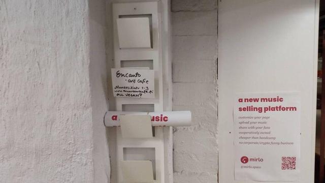 Flyers exchange point at the premises of the Majavan tila cooperative in Kauppalantie 22, Helsinki, with Mirlo and Encanto posters