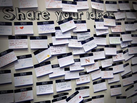 containers for ideas: photograph of a whiteboard labeled "Share your ideas" and covered with numerous sticky notes, each containing handwritten ideas. Photo attribution: Flickr user nanpalmero