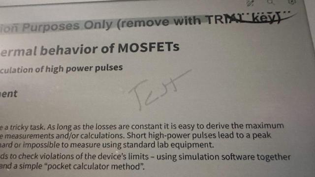 A photo of a Supernote screen showing the same "Test" scribbled on it.