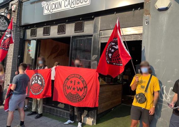 June 15, 2023. 

IWW picket at Kickin’ Caribou in Plymouth, UK. 

Picture Source: https://iww.org.uk/news/plymouth-picket-wins-back-unpaid-wages/