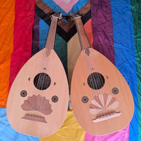 Two ouds I built, on a background of pride flags.