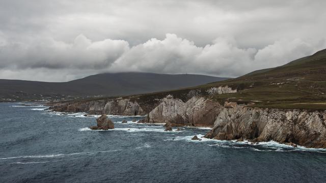 landscape photo of waves crashing agains cliffs