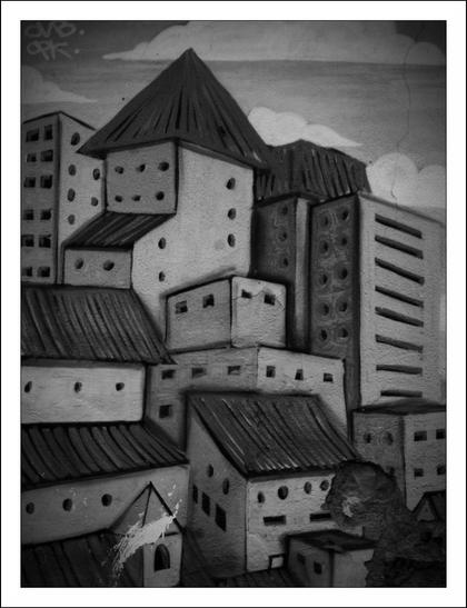 The image depicts a monochromatic streetart work featuring a cityscape dominated by tightly packed buildings of various shapes and sizes. The structures are mostly rectangular with flat or slanted roofs, closely stacked like a dense urban labyrinth. Windows, mostly portrayed as small dark squares or rectangles, punctuate the facades, giving a sense of uniformity and repetition.
The shading and gradient suggest a single light source, which highlights certain edges and creates gentle shadows, adding depth to the otherwise flat surfaces. The overall style of the cityscape has a somewhat surreal or abstract quality, with buildings that seem almost toy-like or simplified, emphasizing geometric forms.
In the lower right corner, a dinosaur or dragon-like figure appears, contrasting sharply with the otherwise orderly architectural environment.