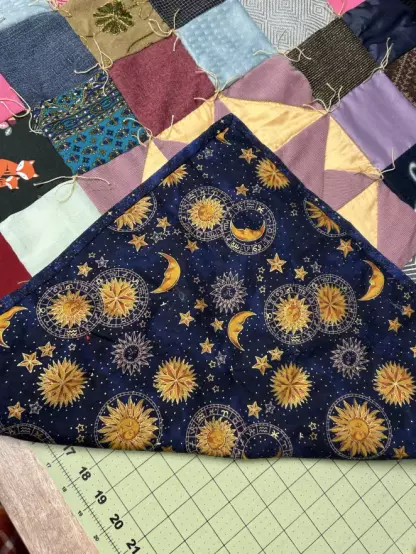 A corner of the back flipped up so you can see it. It's a wonderfully bright moon and star with vivid blue night sky and dense gold for the stars and moon.