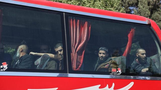 Syrian government and Kurdish-led force exchange prisoners in a step toward easing tensions