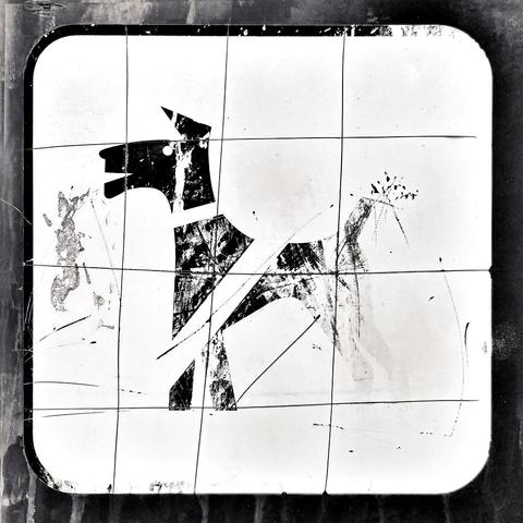 A scratched, worn and decayed "no dogs allowed" sign in black and white, showing a partially faded dog profile silhouette on a white background.
