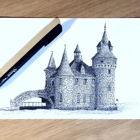 picture of a black and white stippled pen and ink illustration of what appears to be a mall cuboid castle on a river with a small bridge leading off to the left, there is a sharpie pen laid across the paper's upper left corner.