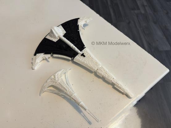 A printed model in black and white plastic on a white table.