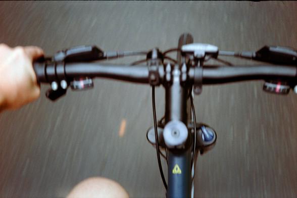An attempt at a downward-looking view of my handlebars taken while riding