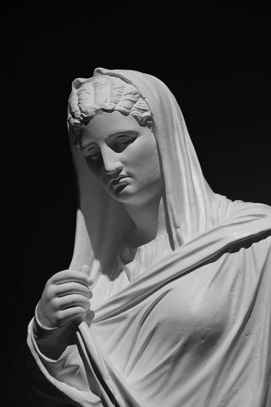 Black and white shot of a classical statue in an Magdeburg (Germany) museum. The figure depicted is female.
