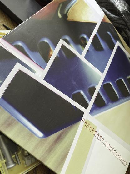 Close-up of the Dashboard Confessional album cover The Places You Have Come to Fear the Most. The design features abstract, overlapping shapes in bold colors. In the lower right corner, the album title and band name are visible.