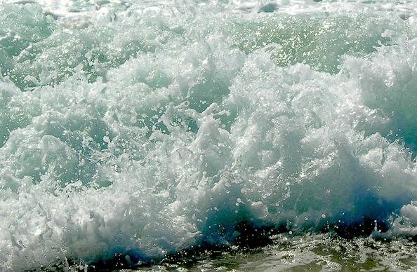 The white froth from the last tumbles of a breaking wave, frozen in time as beautiful, chaotic sculptures, dazzling in the sunshine.