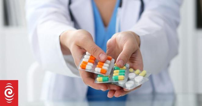 Female doctor hand holding pack of different tablet blisters closeup. Life save service, legal drug store, prescribe medicament, blood pressure, disease healing concept.