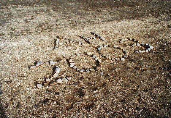Initials and the year 2003 made in small stones.